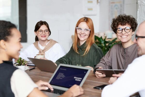 Diverse group of professionals collaborating in an office setting, focusing on teamwork and innovation.